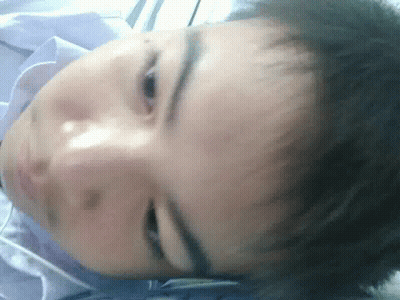A Close Up Of A Person 'S Face With A Blue Shirt On GIF
