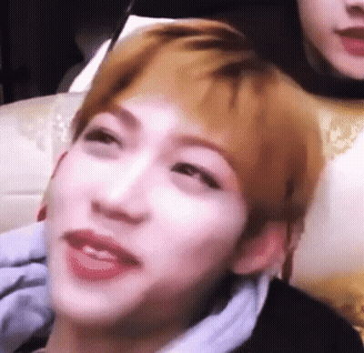 A Close Up Of A Person 'S Face With A Blurred Background And A Person 'S Head In The Background . GIF