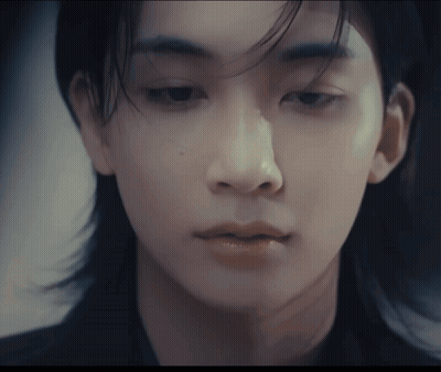 A Close Up Of A Person 'S Face With A Blurred Background GIF