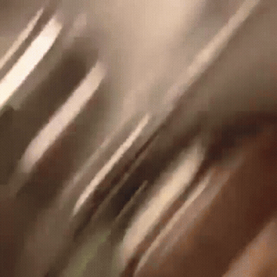 A Close Up Of A Person 'S Face With A Blurry Background GIF