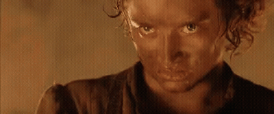 A Close Up Of A Person 'S Face With A Brown Shirt On GIF
