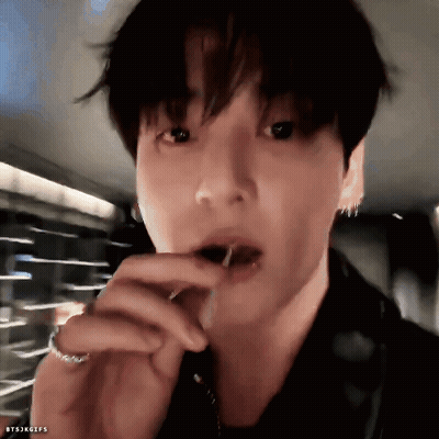 A Close Up Of A Person 'S Face With A Candy In Their Mouth . GIF