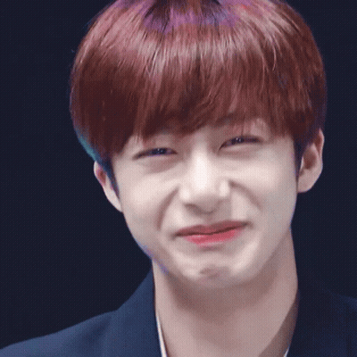A Close Up Of A Person 'S Face With A Dark Background GIF