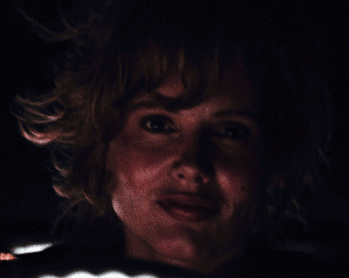 A Close Up Of A Person 'S Face With A Dark Background GIF
