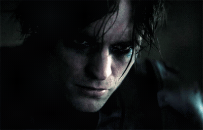 A Close Up Of A Person 'S Face With A Dark Background GIF