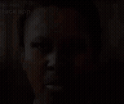 A Close Up Of A Person 'S Face With A Face App Written On It . GIF