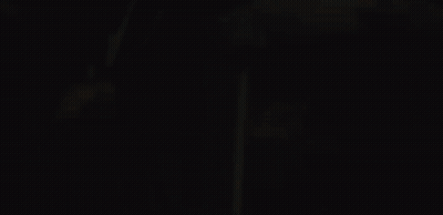 A Close Up Of A Person 'S Face With A Fire Behind Them GIF