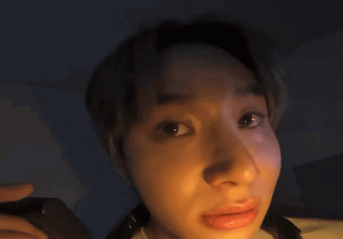 A Close Up Of A Person 'S Face With A Glowing Light Behind Them GIF