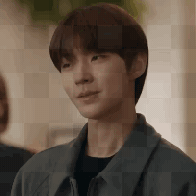 A Close Up Of A Person 'S Face With A Gray Jacket On . GIF