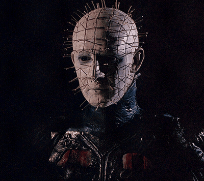 A Close Up Of A Person 'S Face With A Grid Of Pins On It GIF