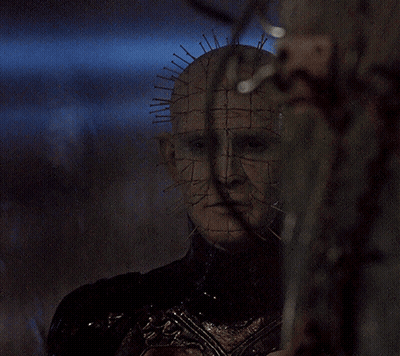 A Close Up Of A Person 'S Face With A Grid Of Spikes On It GIF