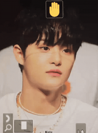 A Close Up Of A Person 'S Face With A Hand Icon Above It GIF