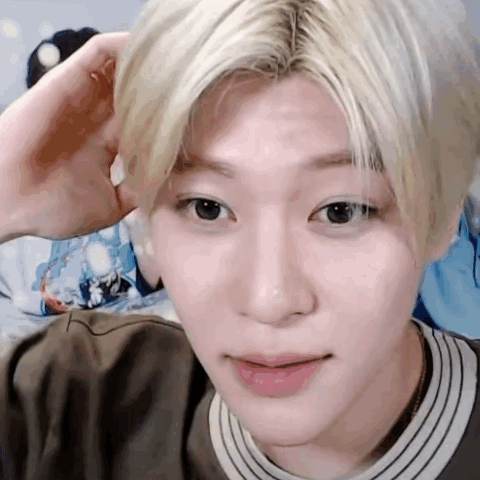 A Close Up Of A Person 'S Face With A Hand On His Head . GIF