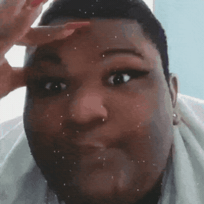 A Close Up Of A Person 'S Face With A Hand On Their Forehead Making A Funny Face . GIF