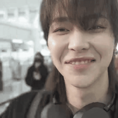 A Close Up Of A Person 'S Face With A Headphone On . GIF