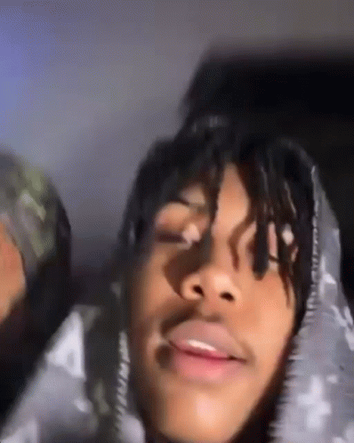 A Close Up Of A Person 'S Face With A Hoodie On . GIF