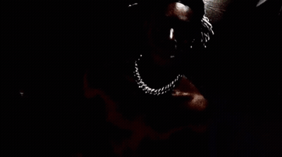 A Close Up Of A Person 'S Face With A Knife In Their Mouth . GIF