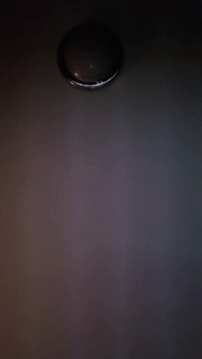 A Close Up Of A Person 'S Face With A Light Behind It GIF