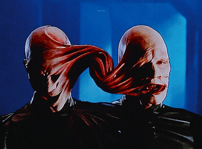 A Close Up Of A Person 'S Face With A Long Tongue Coming Out Of It GIF