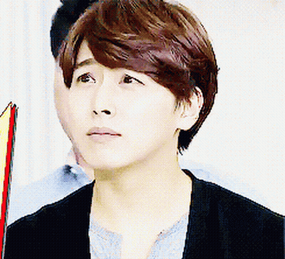 A Close Up Of A Person 'S Face With A Man In The Background GIF