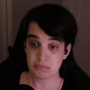 A Close Up Of A Person 'S Face With A Microphone In Front Of Them . GIF