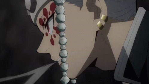 A Close Up Of A Person 'S Face With A Necklace Of Beads Around Their Neck GIF
