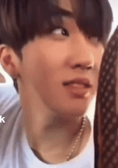 A Close Up Of A Person 'S Face With A Necklace On . GIF
