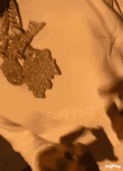 A Close Up Of A Person 'S Face With A Necklace On GIF