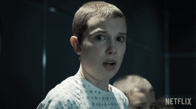 A Close Up Of A Person 'S Face With A Netflix Logo Behind Them GIF