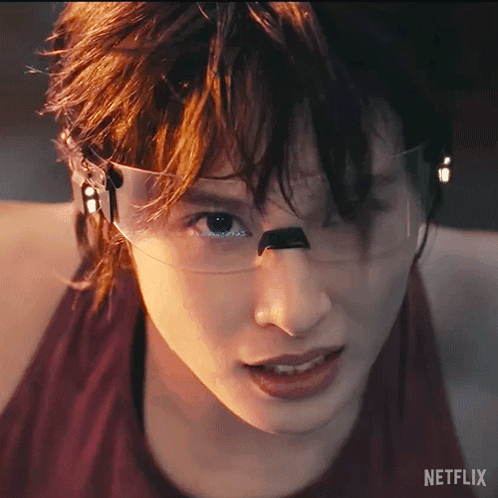 A Close Up Of A Person 'S Face With A Netflix Logo On The Bottom Right GIF