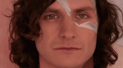 A Close Up Of A Person 'S Face With A Piece Of Tape On It GIF