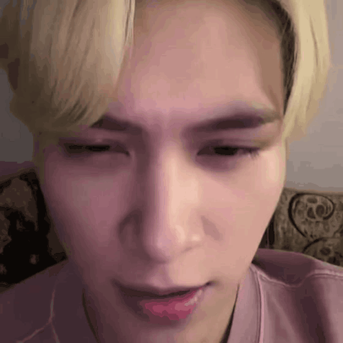 A Close Up Of A Person 'S Face With A Pink Shirt On . GIF