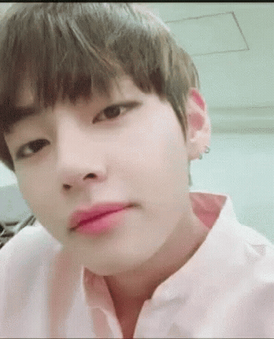 A Close Up Of A Person 'S Face With A Pink Shirt On And A Pink Lip . GIF