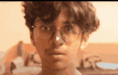 A Close Up Of A Person 'S Face With A Play Button On The Nose GIF
