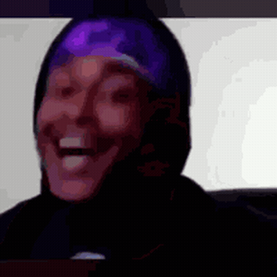 a close up of a person 's face with a purple headband on their head .