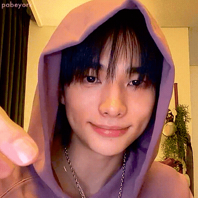 A Close Up Of A Person 'S Face With A Purple Hoodie On GIF