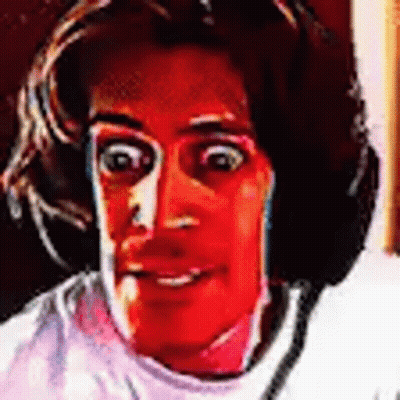 A Close Up Of A Person 'S Face With A Red Background And Headphones On . GIF