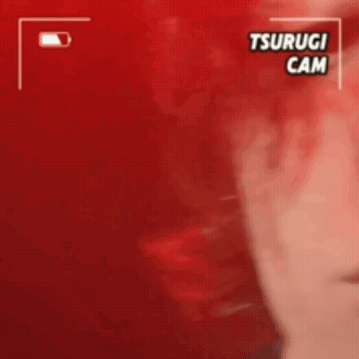 A Close Up Of A Person 'S Face With A Red Background And The Words Tsurugi Cam On It . GIF