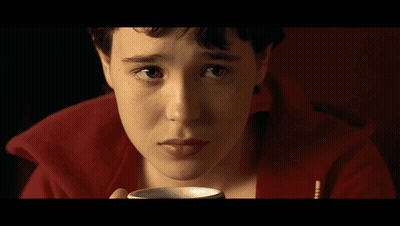 A Close Up Of A Person 'S Face With A Red Sweater On GIF