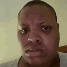 A Close Up Of A Person 'S Face With A Sad Look On Their Face . GIF