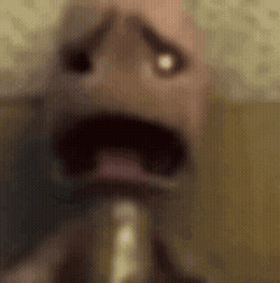A Close Up Of A Person 'S Face With A Saxophone In His Mouth . GIF
