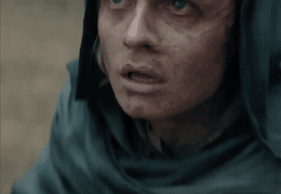 A Close Up Of A Person 'S Face With A Scarf Around Their Head GIF