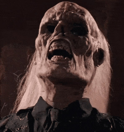 A Close Up Of A Person 'S Face With A Screaming Expression GIF