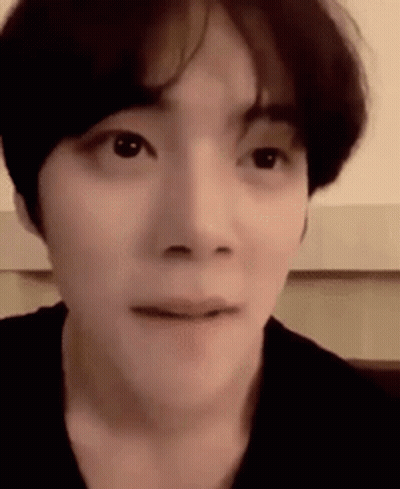 A Close Up Of A Person 'S Face With A Slight Smile On Their Face . GIF