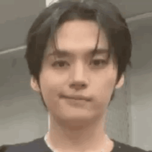 A Close Up Of A Person 'S Face With A Slight Smile On Their Face . GIF
