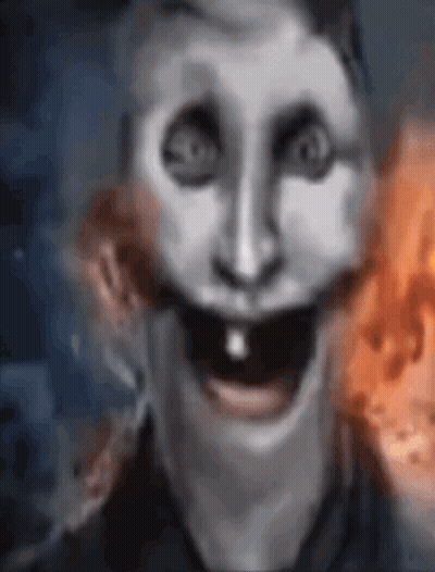 A Close Up Of A Person 'S Face With A Smiley Face And A Fire In The Background . GIF