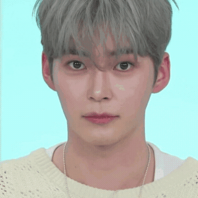 A Close Up Of A Person 'S Face With A Smiley Face Behind Them GIF