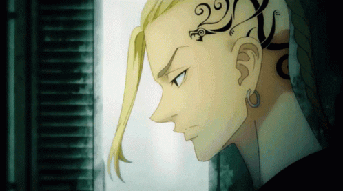 A Close Up Of A Person 'S Face With A Tattoo On The Back Of His Head GIF