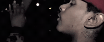 A Close Up Of A Person 'S Face With A Tattoo On Their Neck . GIF