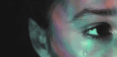 A Close Up Of A Person 'S Face With A Tear Coming Out Of It . GIF